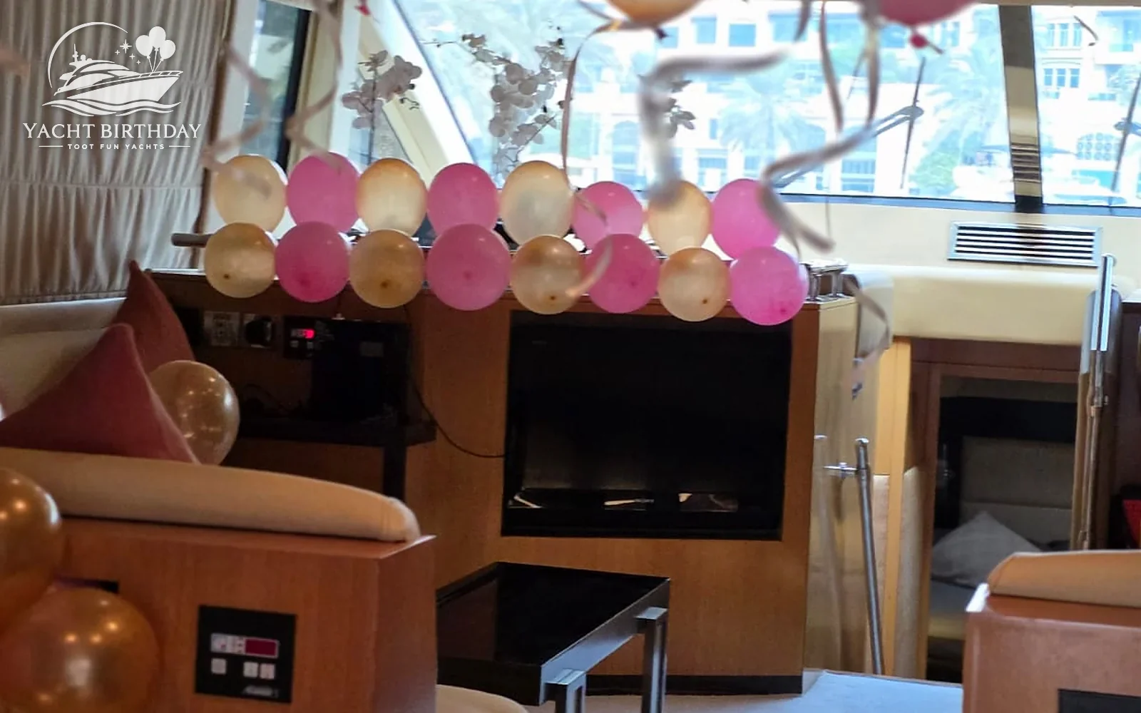 Pink gold balloon garland yacht interior